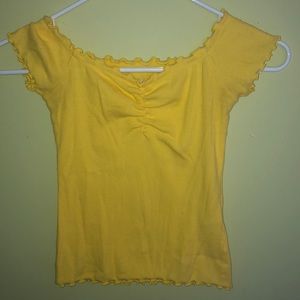 Cinched yellow off the shoulder lettuce edged top